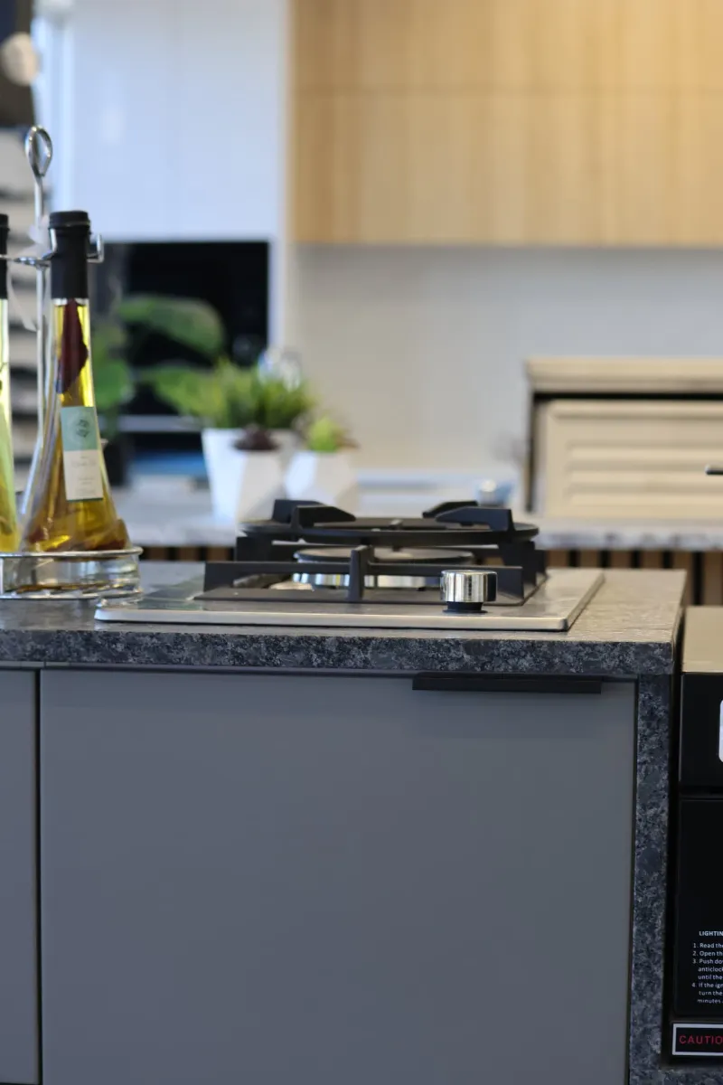 Close-up of a built-in gas cooktop in a custom outdoor kitchen