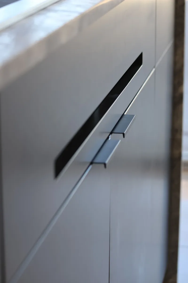 Close-up of modern aluminium cabinet handles on an outdoor kitchen